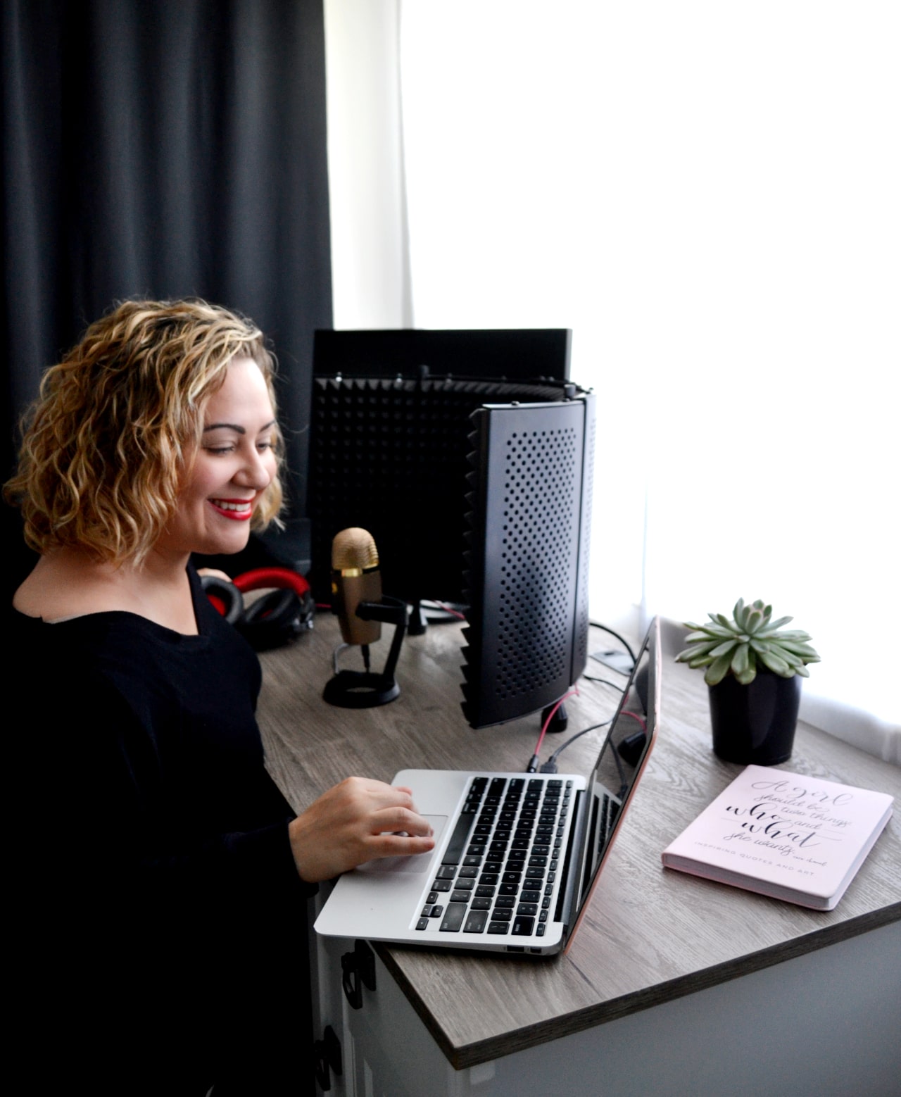 Jannese Torres working on her podcast at her desk.