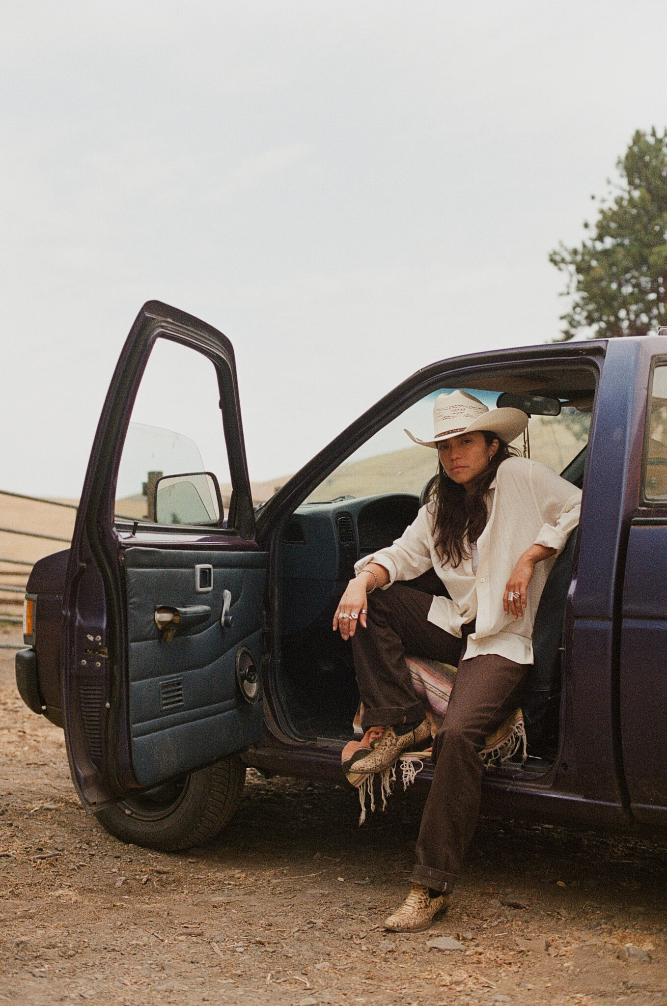 Reyna Tropical promo image, sitting in front seat of truck