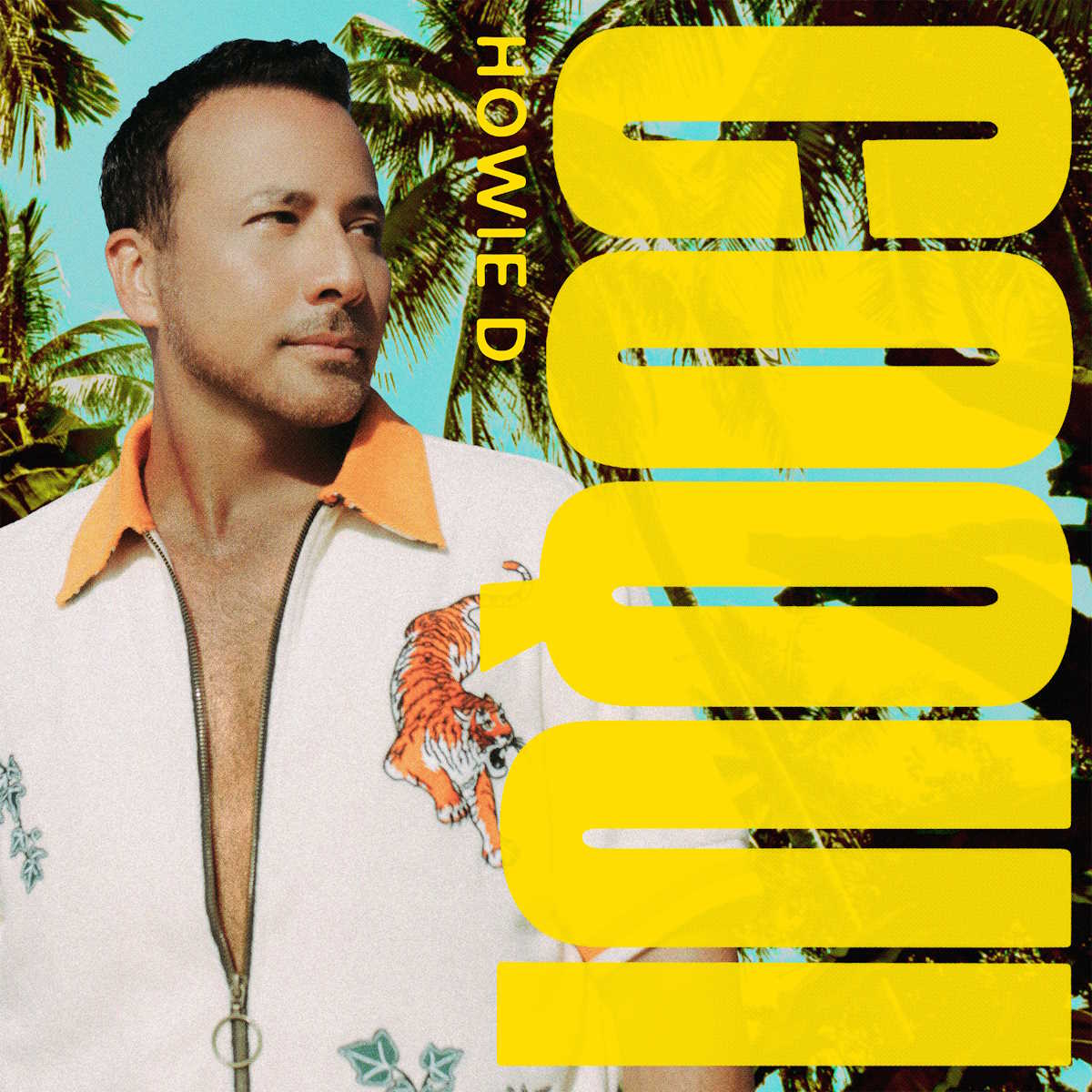 Cover art for Coqui by Howie D. Closeup image of Howie D with palm trees in the background. Coqui is written sideways in large yellow letters, filling the right side of the image.