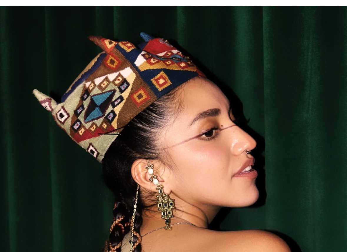 Profile image of Renata Flores. She is wearing a traditional woven headpiece that resembles a crown.